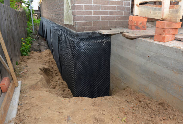 SJ Waterproofing Pros technician performing targeted Basement Waterproofing assessment in Wild Rose, WI
